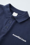Polo shirt with embroidered slogan
