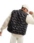 Sean John script puffer heat sealed gilet in black with all over debossing