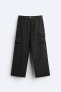 Creased-effect trousers with detachable detail