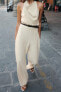 HALTERNECK JUMPSUIT WITH TIE BELT