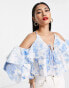 Фото #1 товара ASOS DESIGN ruffle blouse with lace up back in blue floral