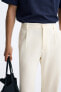 TEXTURED PLEATED TROUSERS