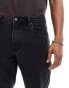 ASOS DESIGN tapered fit jeans with panelling detail in washed black