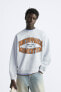 Sweatshirt with printed slogan