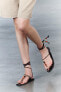 Lace-up leather sandals with beads