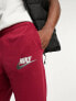 Nike Club Swoosh logo joggers in red