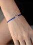 Corded bracelet with blue / steel ring