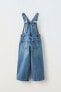 Wide-leg dungarees with buckled straps