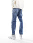 ASOS DESIGN tapered fit jeans with heavy rips in mid wash blue