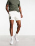 ASOS DESIGN slim shorter length denim cargo shorts with patch in ecru