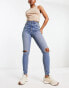 ASOS DESIGN ultimate skinny jean in mid blue with knee rips