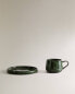 Green stoneware coffee cup and saucer