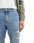 ASOS DESIGN tapered fit jeans with rips in light wash blue - MBLUE