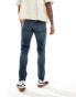 ASOS DESIGN skinny jeans with yellow tint in dark wash blue