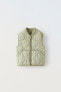 Quilted gilet with piping