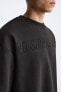 Sweatshirt with embroidered slogan