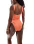 In The Style x Perrie Sian textured ruched side scoop neck swimsuit in orange