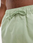 ASOS DESIGN swim shorts in short length in green