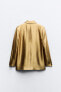 Gold blazer with padded shoulders