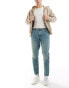 ASOS DESIGN tapered jeans in tinted light wash blue