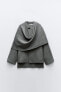Short knit coat with asymmetric scarf