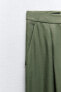 Trousers with darts on the hem