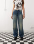 Weekday Ample low waist baggy fit jeans in faded streaky washed blue