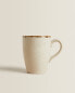 Porcelain mug with antique finish rim