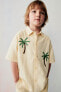 Embroidered sun and palm tree shirt
