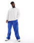 Фото #2 товара ASOS DESIGN baggy nylon track pants in blue with white piping