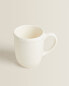 Earthenware mug with a raised-design edge