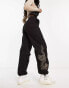 New Look embroidered dragon parachute trousers in black