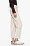 Carrot-fit trousers with darted hems