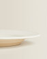 Earthenware dinner dish with raised-design edge