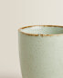 Porcelain mug with antique finish rim