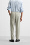 TEXTURED PLEATED TROUSERS