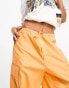 Weekday Unisex parachute baggy trousers in orange exclusive to ASOS