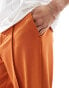 ASOS DESIGN smart wide leg trousers with pintucks and side splits in rust