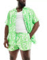 ASOS DESIGN swim shorts in short length in green print