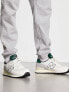 Фото #1 товара New Balance 574 trainers in off white and dark green