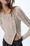 Asymmetric open-knit sweater