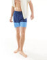 ASOS DESIGN swim shorts in mid length with cut and sew detail in blue