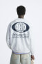 Sweatshirt with printed slogan