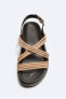 Sandals with criss-cross straps
