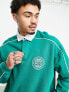 ASOS DESIGN oversized rugby sweatshirt with piping in green