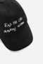 CAP WITH EMBROIDERED SLOGAN