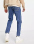 ASOS DESIGN tapered jeans in mid wash blue with knee rips