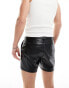 ASOS DESIGN slim leather look shorts with lace up details in black