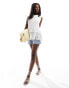 In The Style knitted sleeveless tassel hem top in white