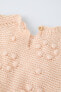 Knit sweater with beaded detail